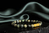 Rengetsu Gaishin Armored Will luxury Kambaba Jasper men’s bracelet 18 cm displayed on black stone with draped green satin background – signature piece photoshoot