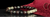 Rengetsu Rekka Raging Flame luxury Garnet men’s bracelet displayed on onyx plate with suede background, red pocket square and cufflinks – styled product photoshoot