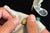 Hands assembling a Rengetsu Ryokuken Green Blade men’s bracelet – mastery1